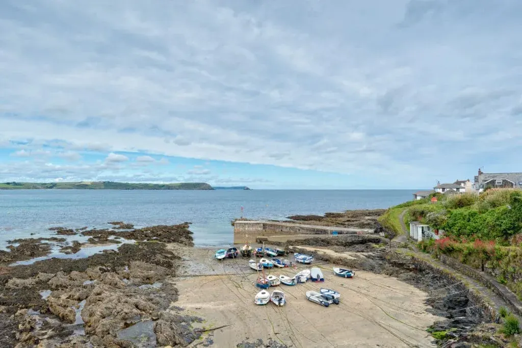A cloudy sky over the harbour and beach at Portscatho