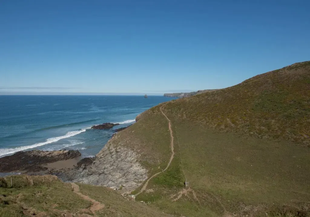Hiking along the South West Coast Path with Tregardock Beach in the background