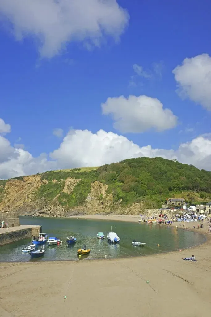 Polkerris Beach and Harbour, a small sandy beach sheltered by a historic harbour wall.