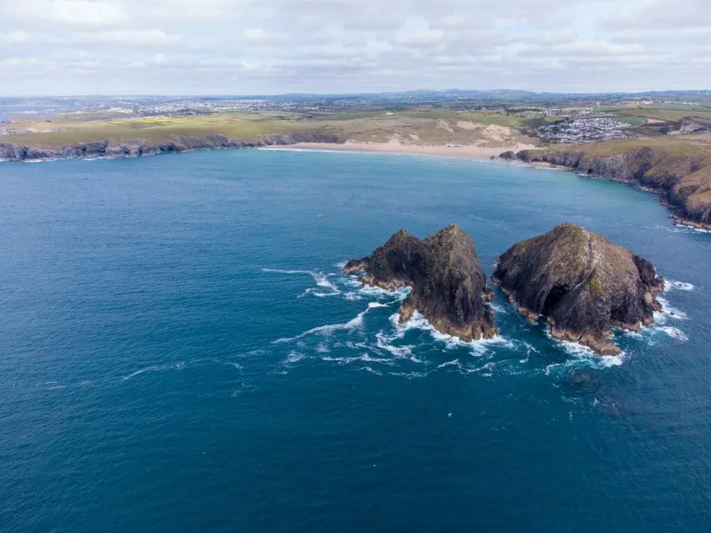 An aerial photo of Holywell Bay from behind the Gull Rocks, Newquay, Cornwall