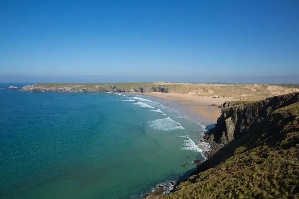 Holywell Bay Beach in North Cornwall with on a clear summer day at high tide