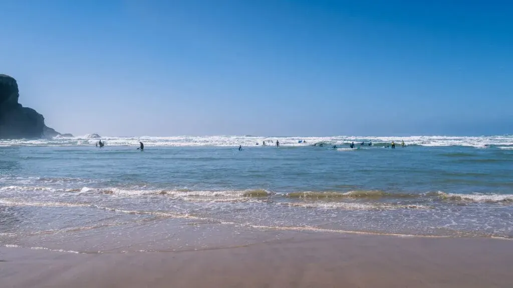 Surfers and bodyboarders make the most of the big waves at Mawgan Porth Beach, Newquay, Cornwall