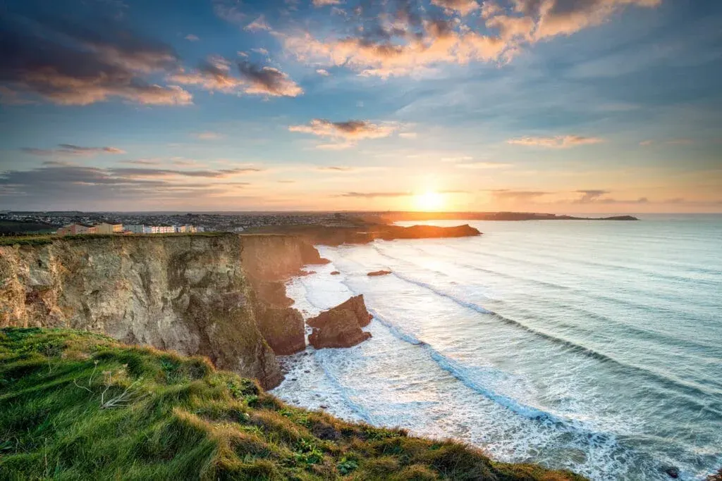 A stunning, dramatic sunset from cliffs over Whipsiderry Beach, Newquay, Cornwall