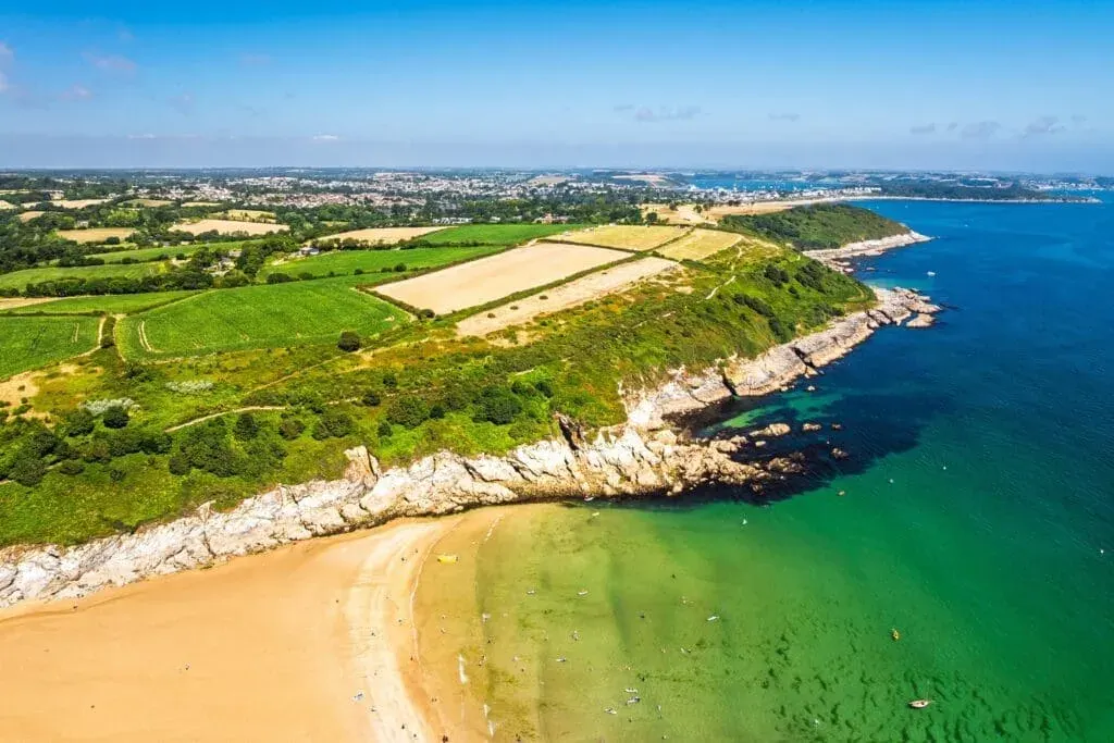 Cliffs over Maenporth Beach and stack point from a drone, Falmouth Bay, Falmouth, Cornwall