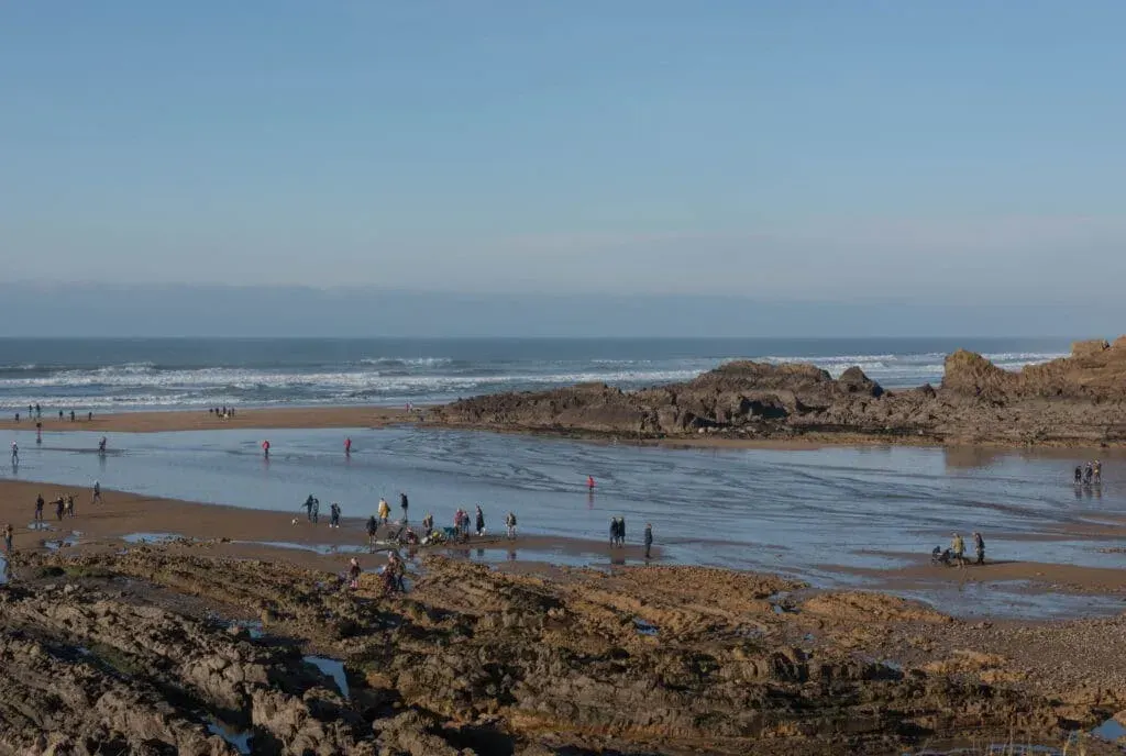 People enjoying the winter sun on Summerleaze Beach, Bude, Cornwall