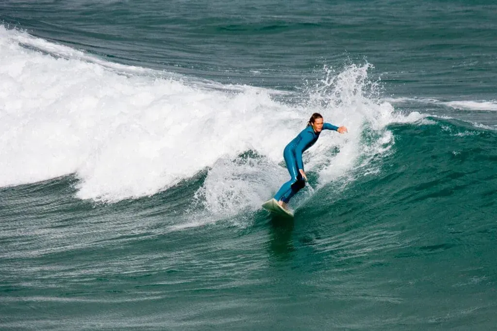 A surfer on the waves at Fistral Beach, Newquay, Cornwall