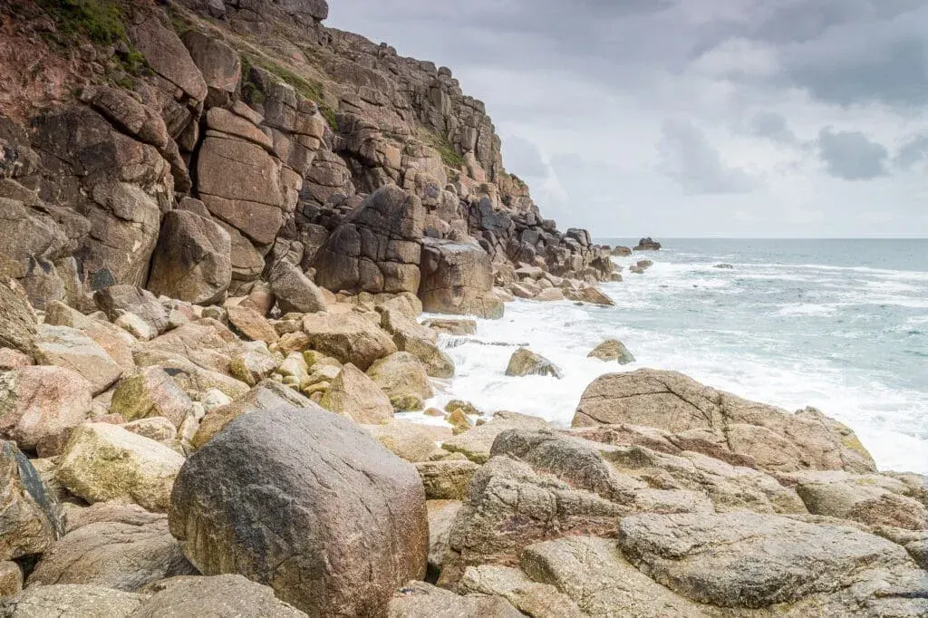 Boulders and rocks, showing the more rugged side to Chapel Porth Beach on the North Cornwall coast.