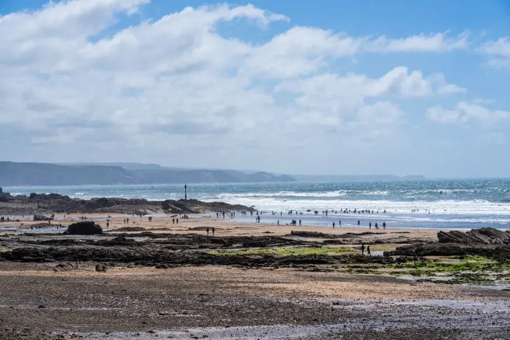 Tourists and locals enjoying the winter sun on Summerleaze Beach, Bude, Cornwall